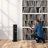 Dynaudio Emit 30, grindinės garso kolonėlės - Kolonėlė su trimis garsiakalbiais ir vyras prie lentynos