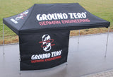 Ground Zero palapinė 3x6m - priekinė panelė su logotipu ir užrašais
